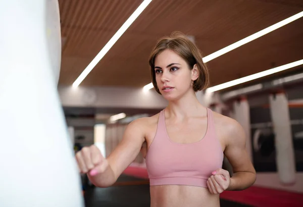 A young woman practising karate indoors in gym. Copy space. — Stock Photo, Image