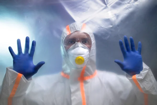 Man with protective suit and respirator indoors, coronavirus concept. — Stok fotoğraf