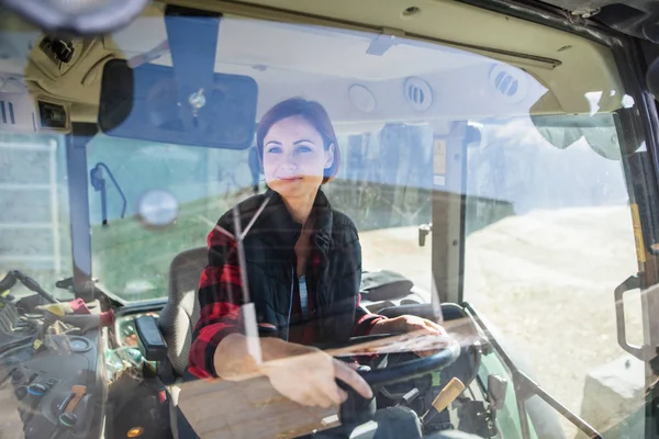 Mujer trabajadora montando tractor en granja diario, industria agrícola . — Foto de Stock