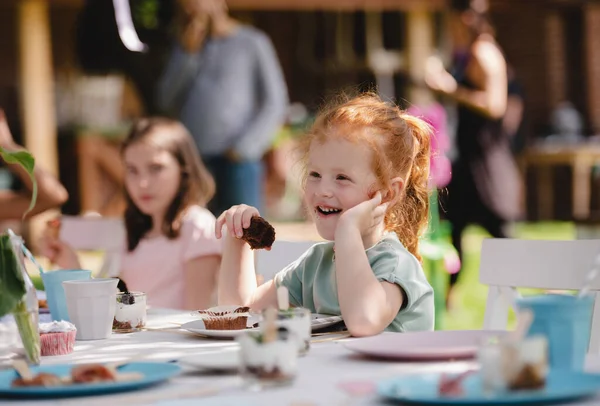 夏のガーデンパーティーで食べる小さな子供、誕生日のお祝いのコンセプト. — ストック写真