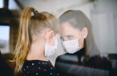 Evde maskeli anne ve çocuk, Corona virüsü ve karantina konsepti..