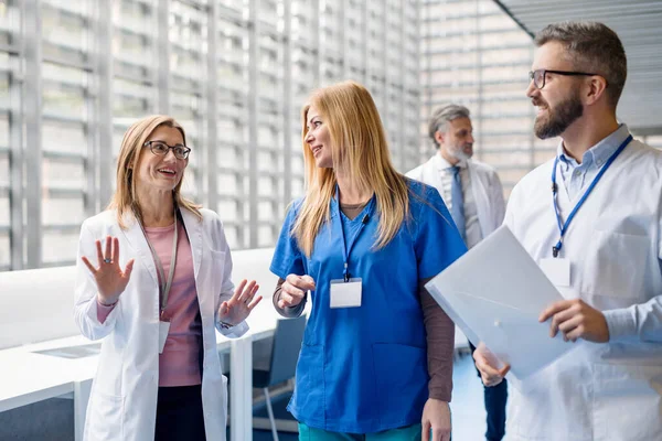 Group of doctors walking in corridor on medical conference. — Stock Photo, Image