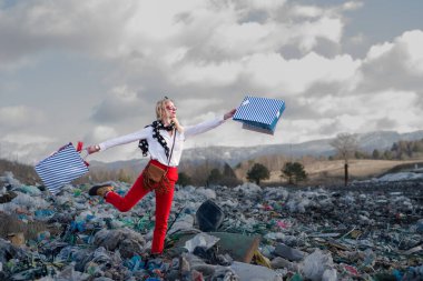 Modern woman on landfill, consumerism versus pollution concept. clipart