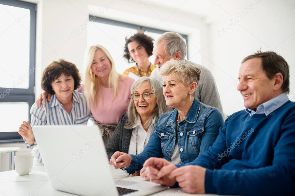 Group of senior people attending computer and technology education class.