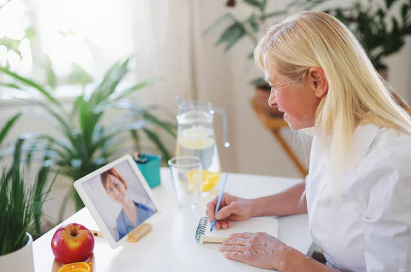 Senior woman with laptop at home , consulting doctor and video call concept. — Stock Photo, Image