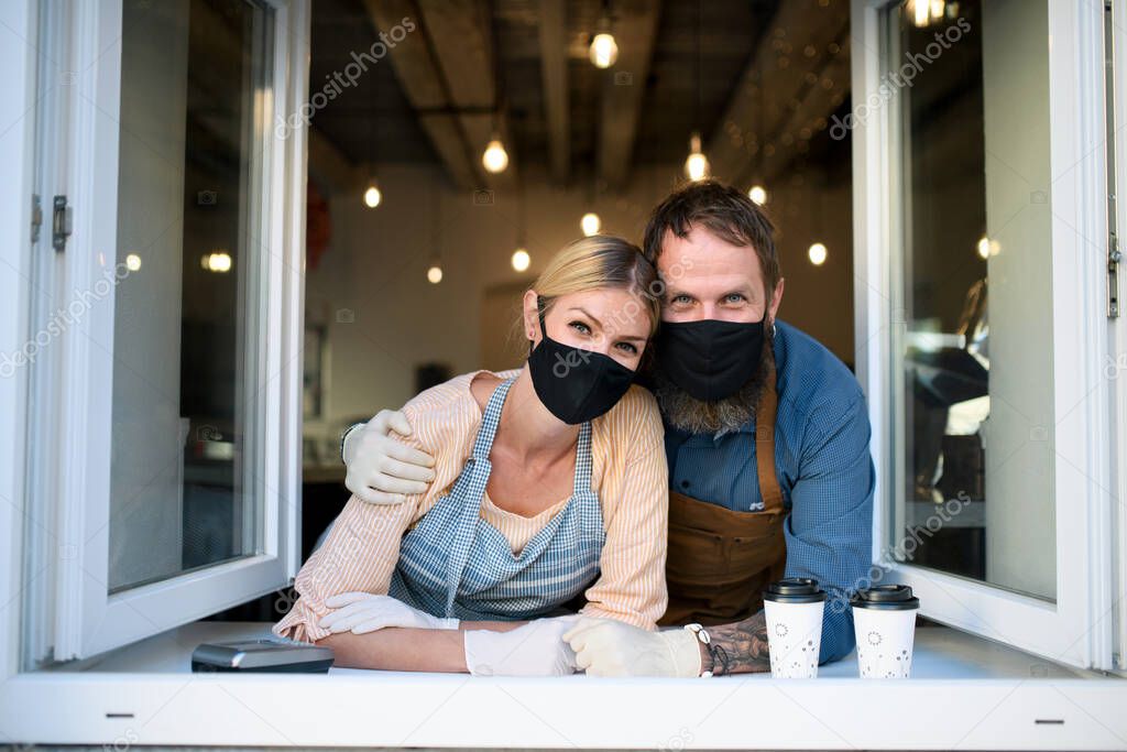 Coffee shop owners with face masks, lockdown, quarantine, coronavirus, back to normal concept.