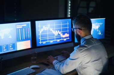 Bilgisayarlı bir iş adamı geç saatlere kadar çalışıyor. Mali kriz kavramı.