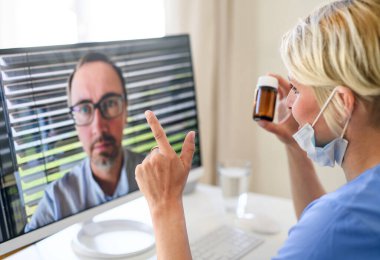 Kadın doktor bilgisayarında hastasıyla görüntülü görüşme yapıyor, online danışma konsepti..