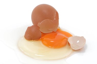 Beyaz bir yüzeyde çiğ yumurta çatladı.