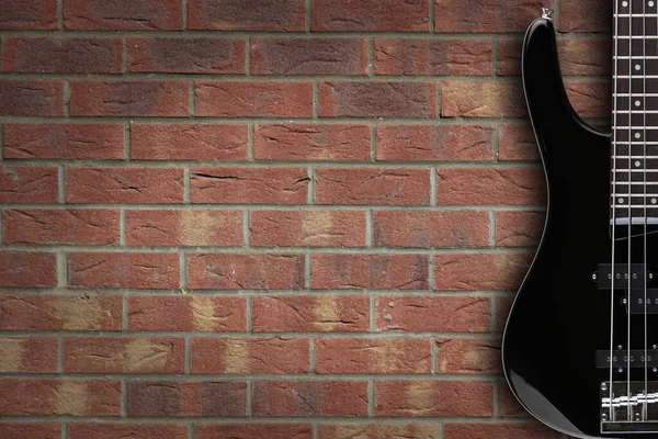 Bass guitar on brick background with copy space — Stock Photo, Image