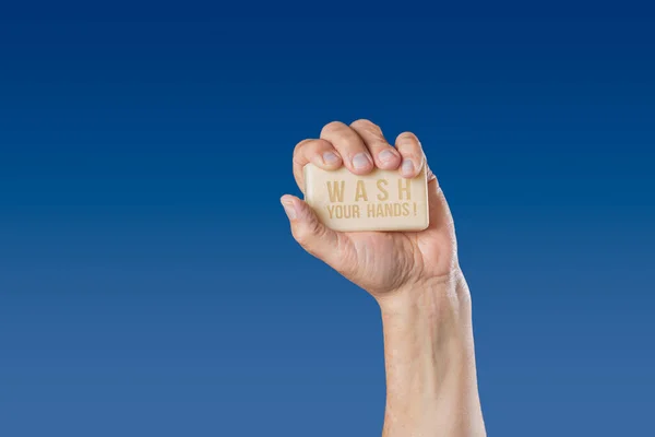 Caucasian male hand holding bar of soap with message Wash Your Hands — Stock Photo, Image