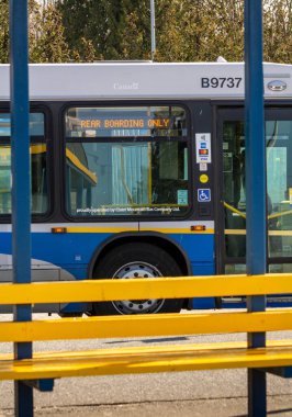 N. Vancouver, Kanada - 7 Nisan 2020: Yolculara Covid-19 salgını sırasında arka kapıdan girmeleri için mesaj gösteren toplu taşıma otobüsü