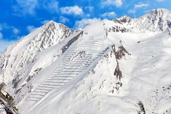 Avalanche protection barriers on mountainside — Stock Photo, Image