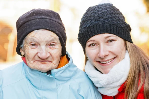 Elderly woman and young carer — Stock Photo, Image
