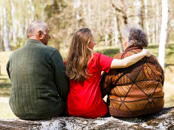 Elderly couple and young caregiver — Stock Photo, Image