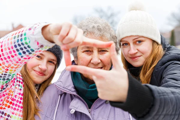 Elderly woman and granddaughters