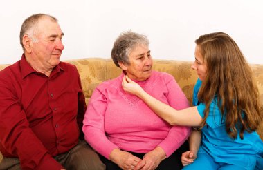 Mutlu yaşlı çift ve genç caregiver