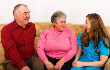 Mutlu yaşlı çift ve genç caregiver