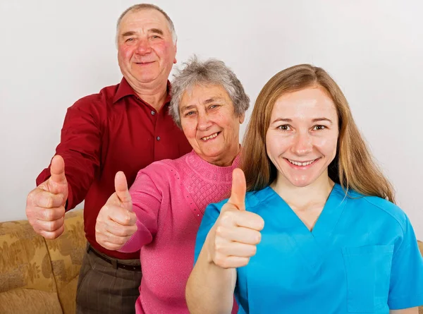 Mutlu yaşlı çift ve genç caregiver