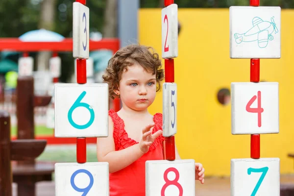 Little girl playing on the playground — Stock Photo, Image