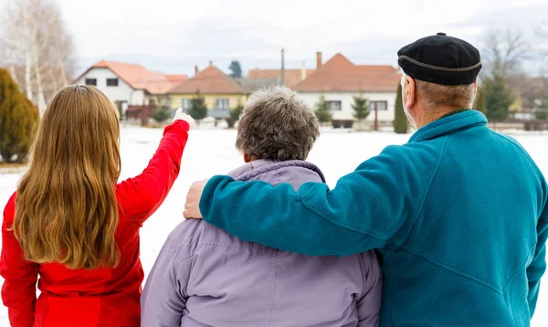 Elderly couple and young caregiver — Stock Photo, Image