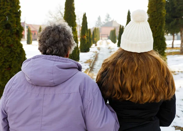 Elderly woman and young caregiver — Stock Photo, Image