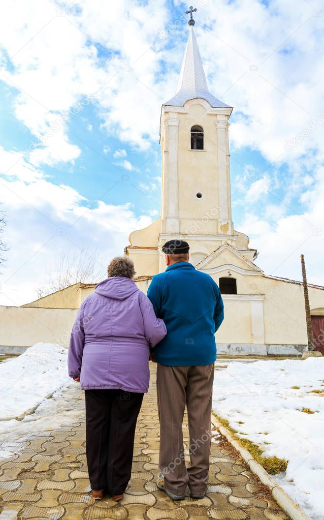 Elderly couple going to the church