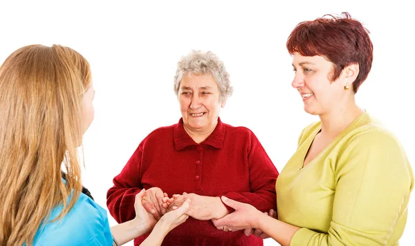 Elderly woman with carer and the young doctor — Stock Photo, Image