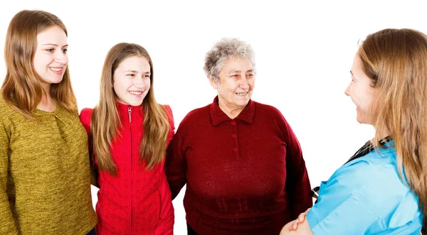 老年妇女与 granddaugthers 和年轻的医生 — 图库照片