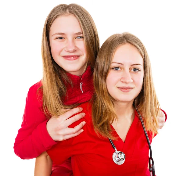 Young female doctor and her sister — Stock Photo, Image