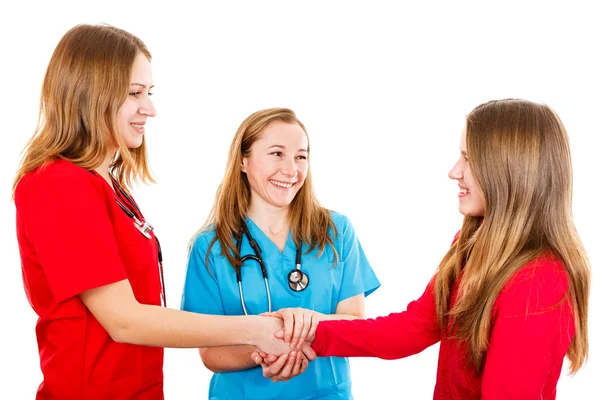 Smiling young girl and pediatricians — Stock Photo, Image