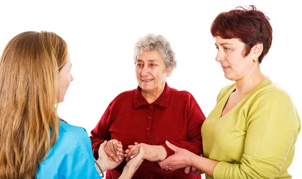 Elderly woman with carer and the young doctor — Stock Photo, Image