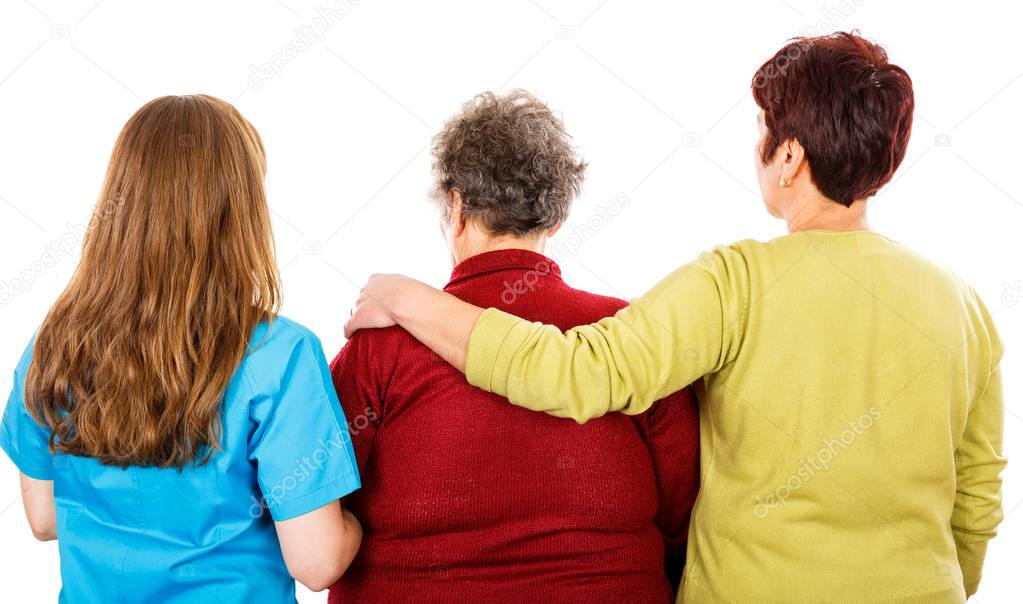 Elderly woman and young caregivers