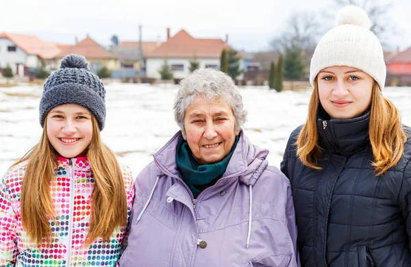 Elderly woman and granddaughters — Stock Photo, Image