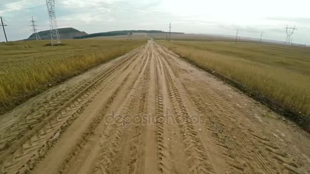 Onverharde weg in een veld — Stockvideo