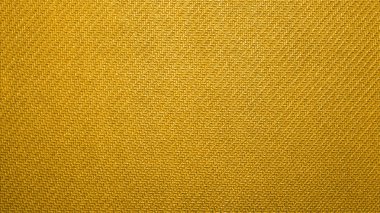 Sarı bağlayıcı kumaş dokusu. Sarı arkaplan. Sarı kumaş. Desenli yüzeyi olan bir arkaplan.