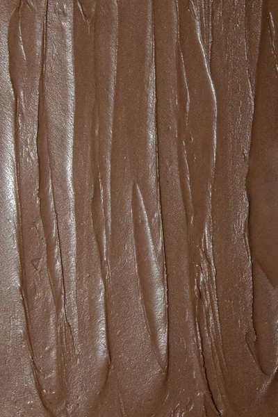 Chocolate paste.Texture of milk chocolate.The background of chocolate.The texture of chocolate butter.