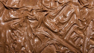 Erimiş çikolatanın dokusu. Erimiş çikolatanın arkaplanı..