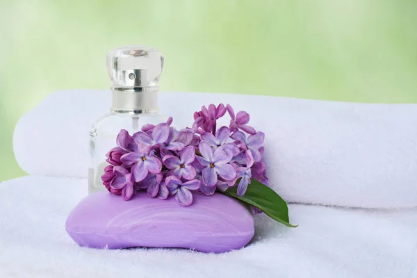 Soap and perfume bottle with lilac flowers — Stock Photo, Image