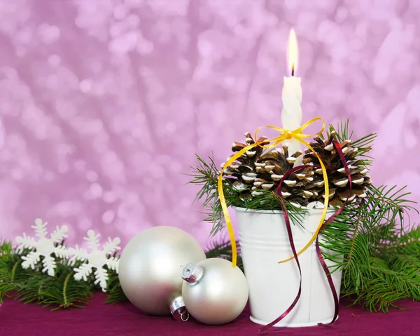 Burning candle with Christmas baubles — Stock Photo, Image