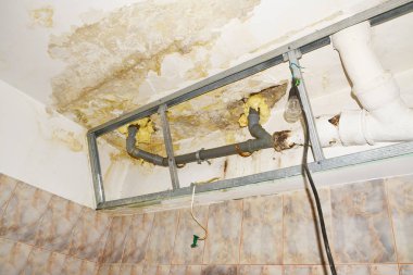Water damage in condo bathroom ceiling, flooding from upstairs neighbor clipart