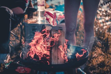Camping with campfire on a lake
