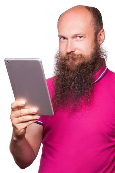 Portrait of bald bearded man with tablet and pink t-shirt isolated on white background. — Stock Photo, Image