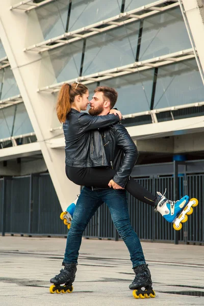 Beau couple de patineurs à roulettes avec style hipster patinant après la pluie . — Photo