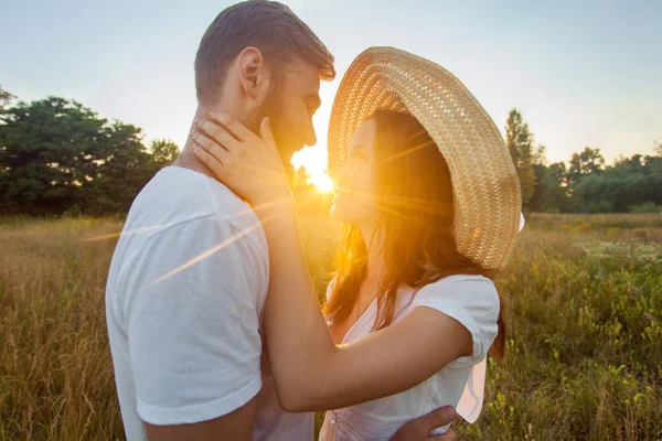 Happy beautiful couple hugs in park in the on the sunset. — Stock Photo, Image