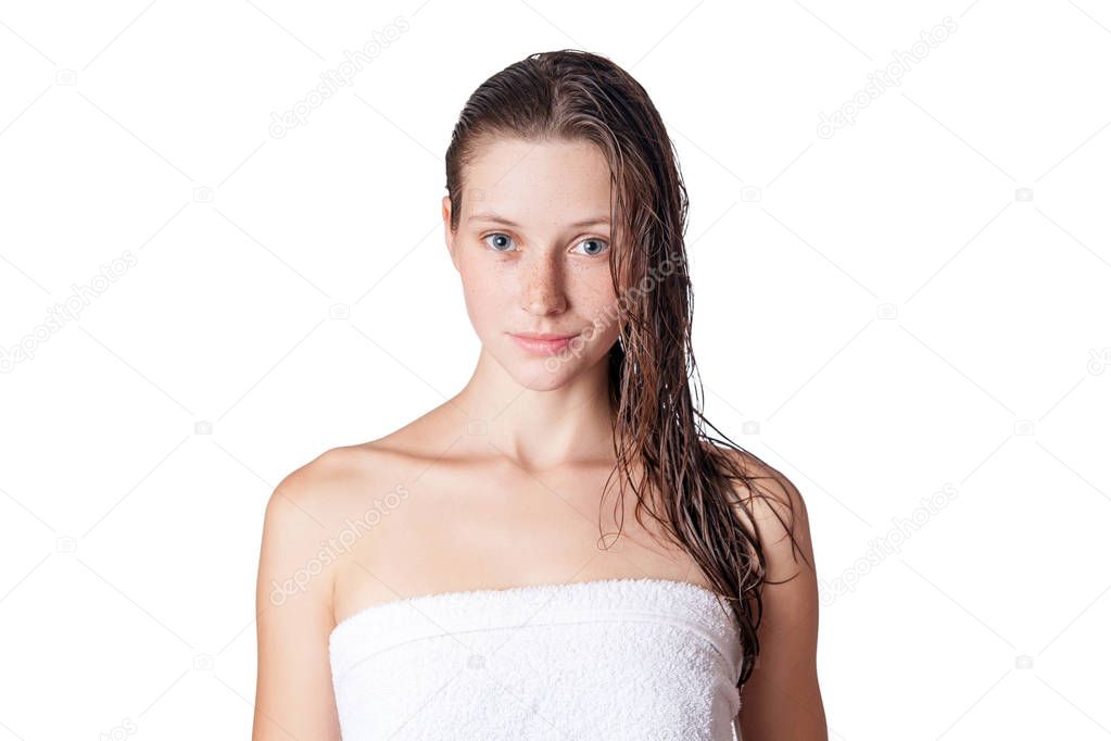 Portrait of a beautiful model with wet hair and clean skin and freckles after shower isolated on white background.