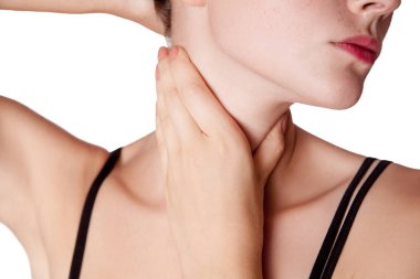 Closeup view of a young woman with pain on neck or thyroid gland. clipart