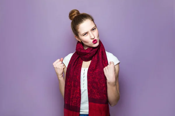 Surprised winner woman. Young emotional beauty with collected hair, freckles and red scarf looking excited on purple background, emotions, expressions, success concept and celebrating victory.
