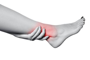 Closeup view of a young woman with pain on leg. isolated on white background. Black and white photo with red dot. clipart
