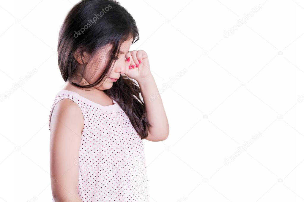 Sad crying unhappy small beautiful girl with dark hair and eyes. studio shot, isolated on white background.